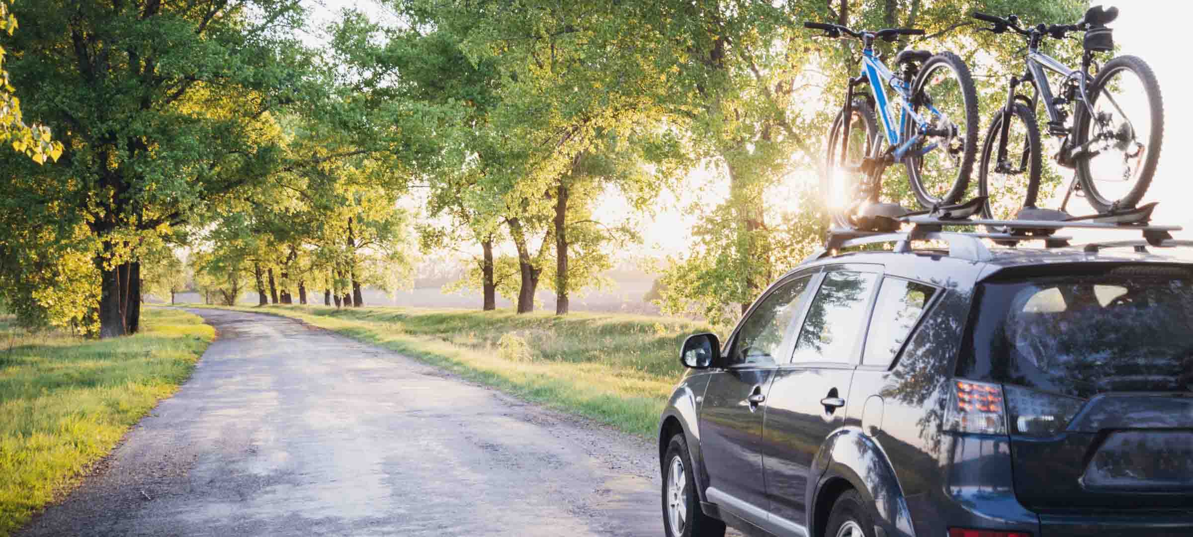 Car with bike on top load carrier
