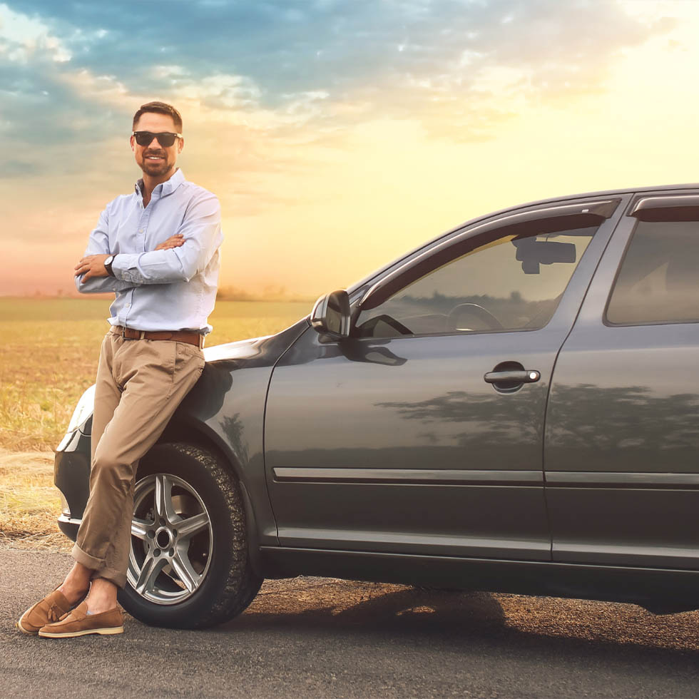 man leaning on his car